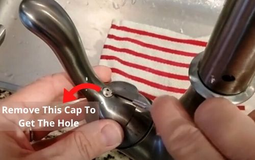 Remove the plastic cap of the moen faucet