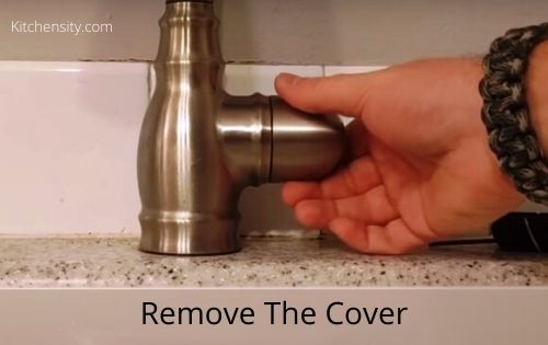 Remove the moen faucet cover